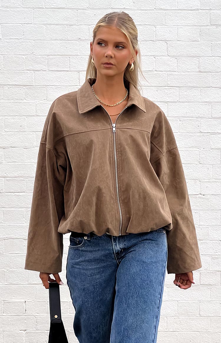 Front view of an oversized brown suedette bomber jacket with a pointed collar, silver zipper, and bubble hem