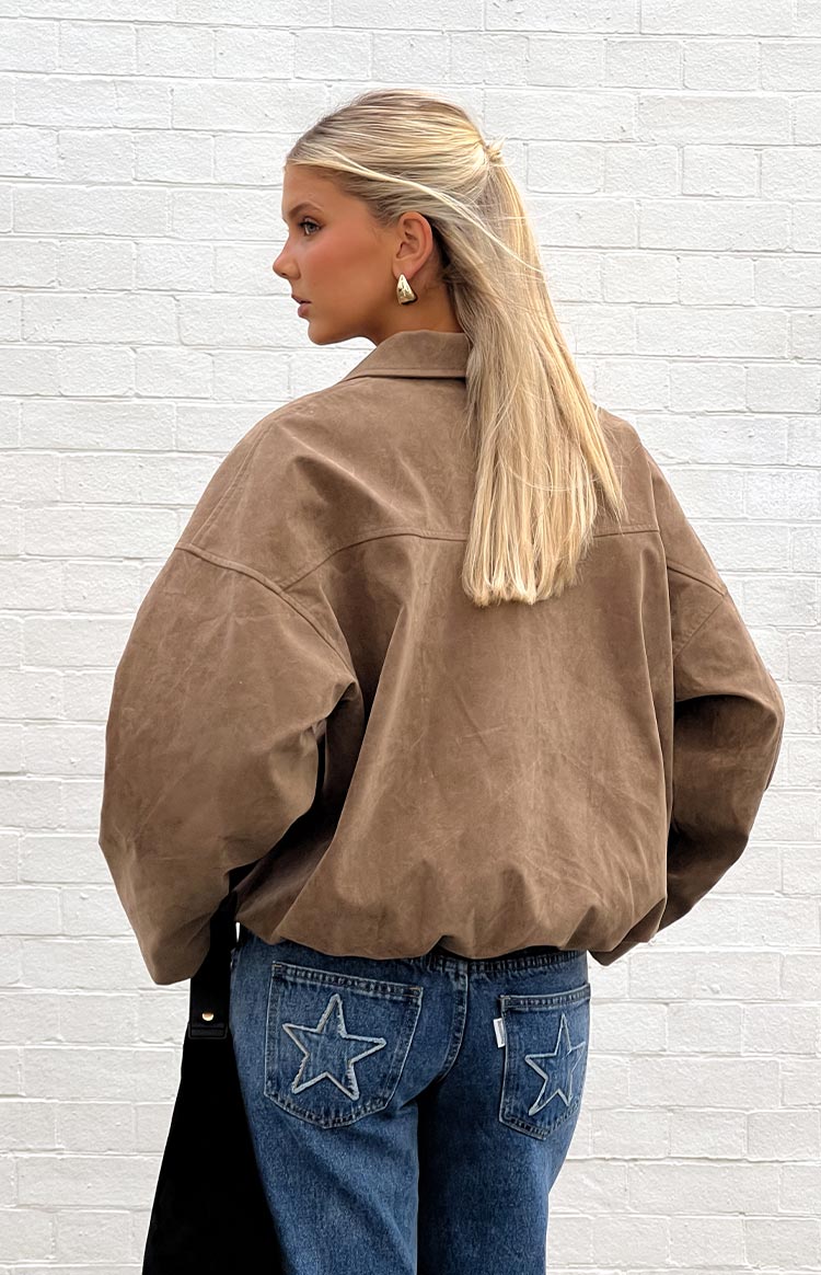 Side view of a brown suedette bomber jacket with dropped shoulders and a bubble hem