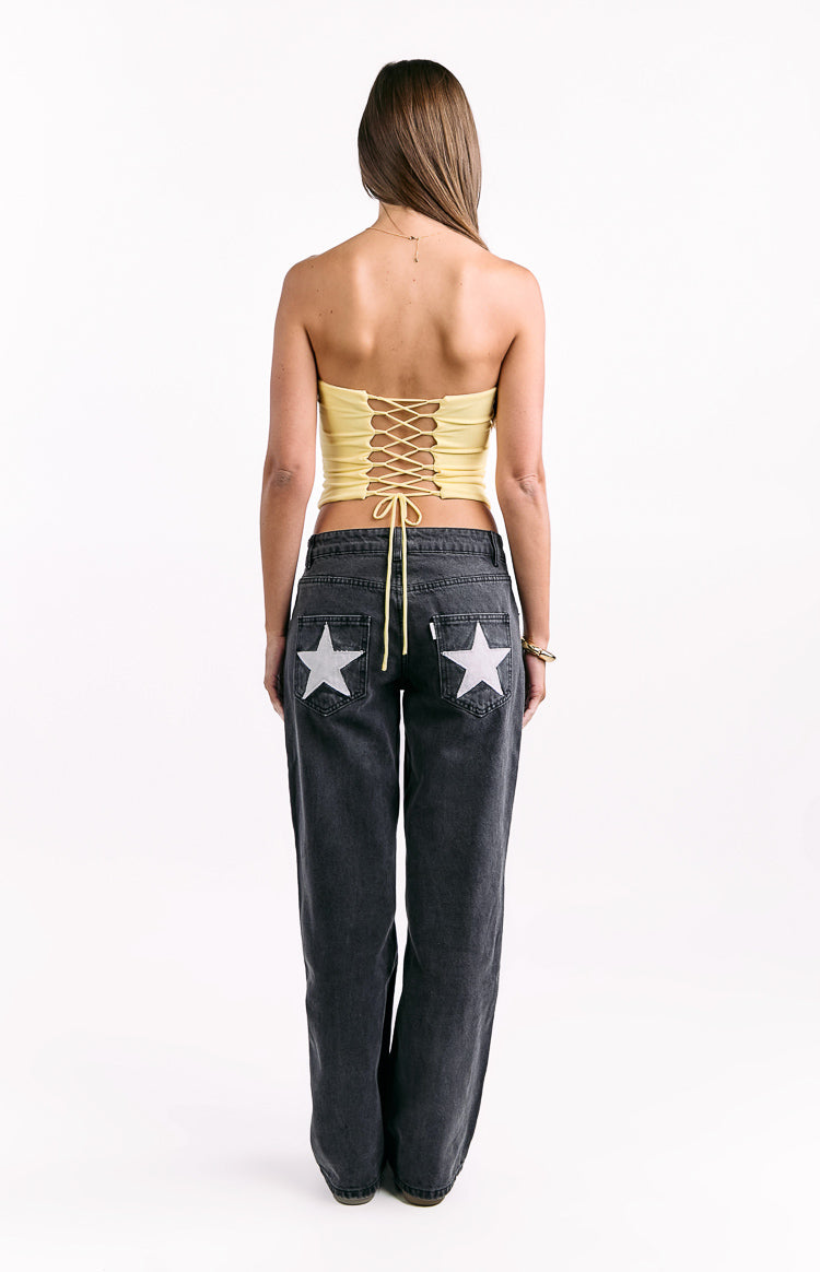 Rear view of a yellow strapless corset top with a full lace-up back and tie strings