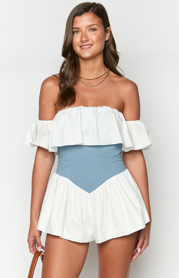 Front view of an off-shoulder white ruffle playsuit with a light blue denim corset waist and gathered white shorts