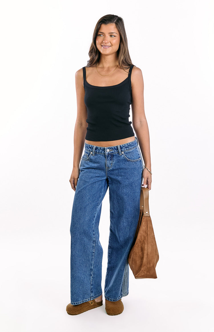 Front view of mid wash denim low rise wide leg jeans with a subtle contrast stripe