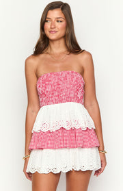 Shirred red and white gingham strapless mini dress with tiered white broderie anglaise skirt and scalloped edges