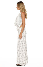 Side view of a white polka dot mesh top with a draped bodice and side waist cutout