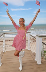 Red gingham babydoll mini dress with a square neckline, short puff sleeves, and a gathered skirt
