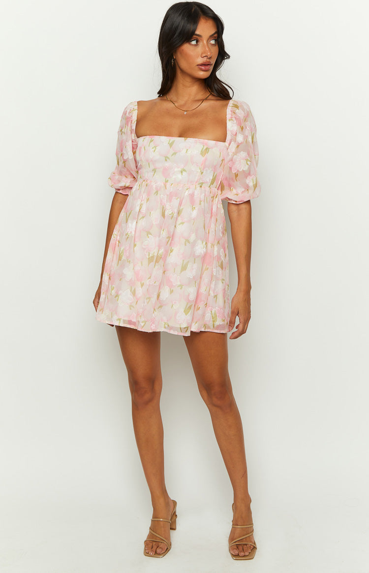 Front view of a pink floral babydoll mini dress with a square neckline and short puff sleeves