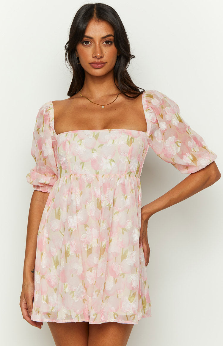 Pink floral babydoll mini dress with a square neckline, elbow-length puff sleeves, and gathered waist