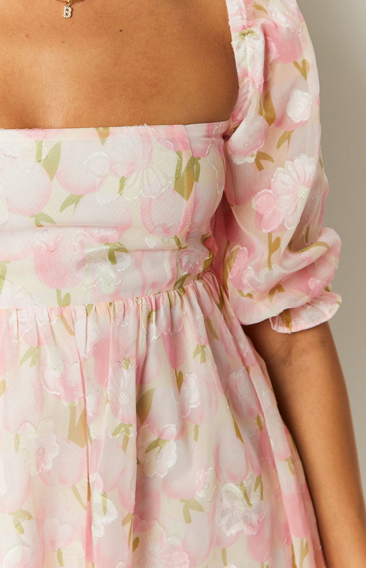 Close-up of the pink floral babydoll mini dress with textured floral pattern, square neckline, and puffed sleeves