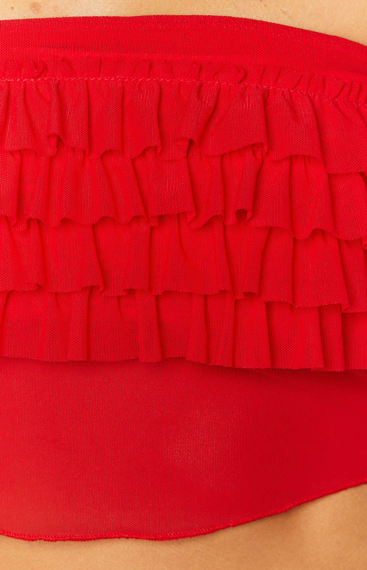 Close-up of the tiered red ruffles made from sheer mesh fabric on the tube top