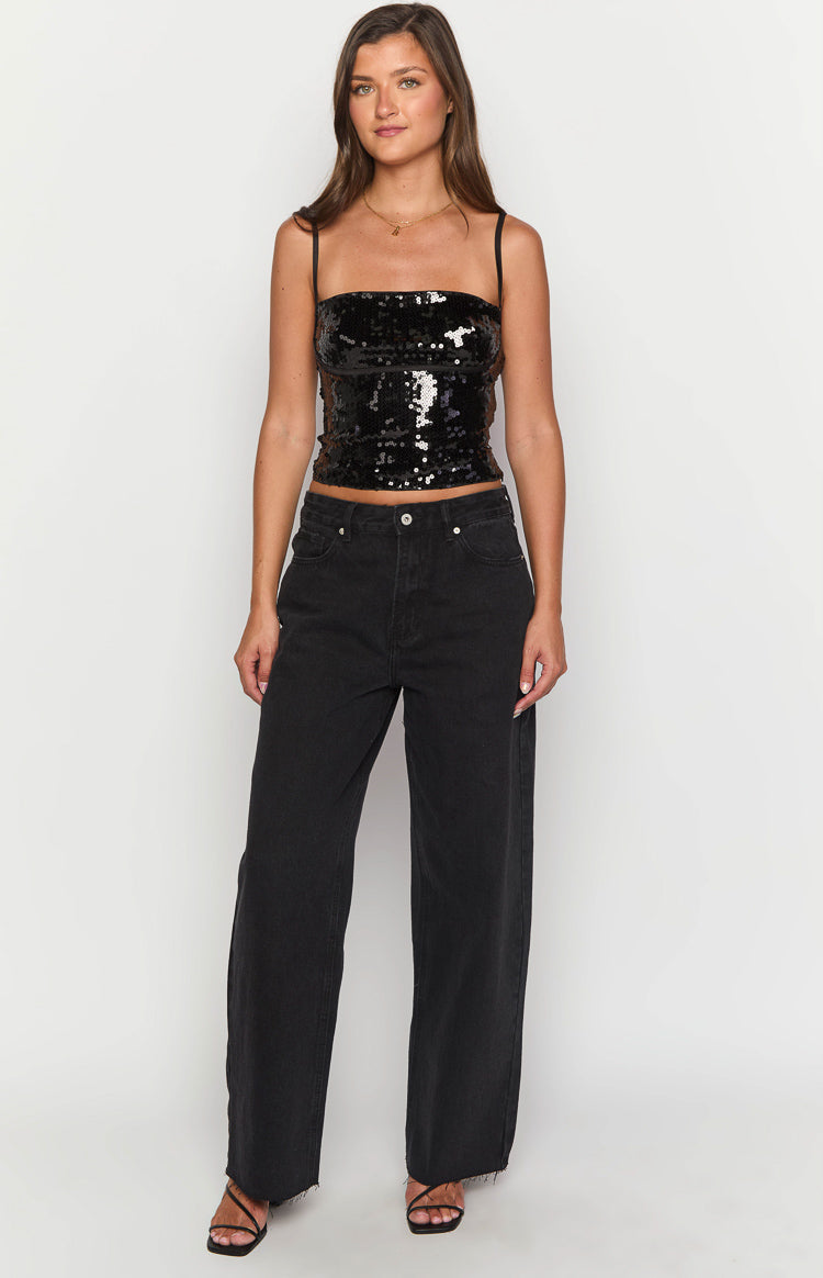 Front view of black wide leg boyfriend jeans with a high waist and distressed raw hem