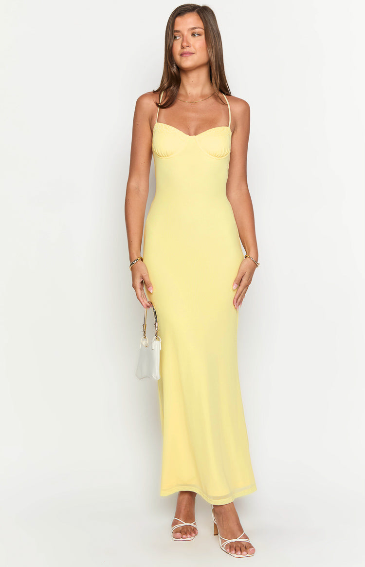 Front view of a yellow maxi dress with a sweetheart neckline, bust cups, and thin spaghetti straps
