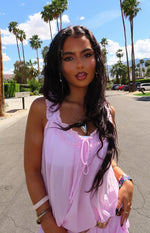 close up of a girl with a pink dres and dark hair 