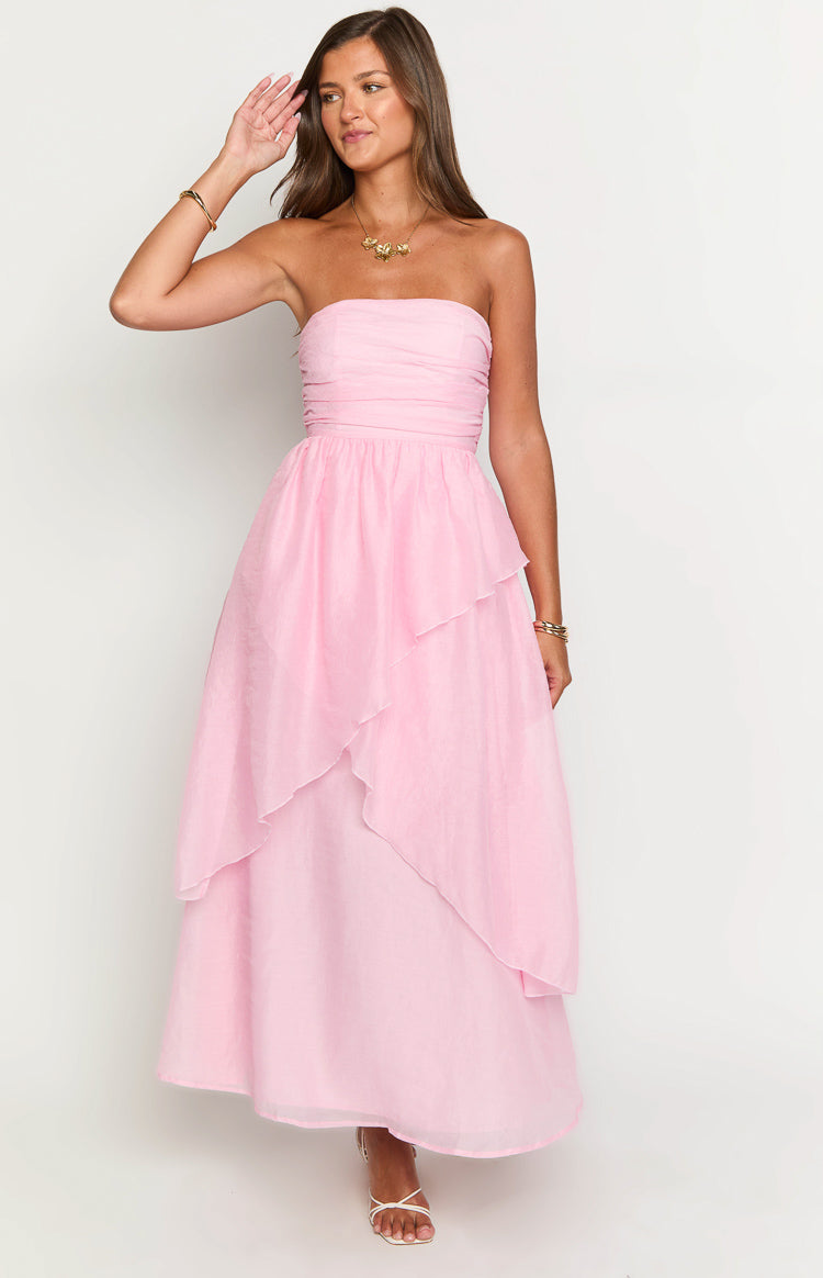 Pink strapless maxi dress with ruched bandeau bodice, fitted waist, and a flowy tiered skirt with asymmetrical layers