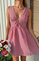 Front view of a red gingham mini dress with a deep V-neckline and tie-front detail at the waist