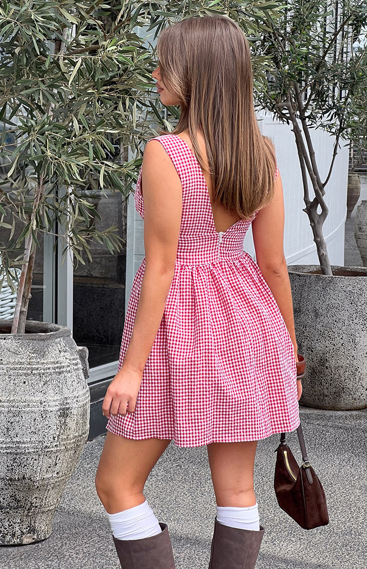 Rear-side view of a red gingham mini dress with a low scoop back and white zipper closure