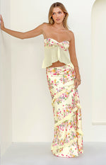 Yellow satin maxi skirt with a pink and purple floral print and diagonal ruffles