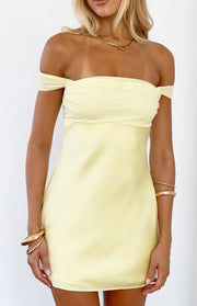 Close-up of the yellow off-shoulder mini dress with a ruched bust and smooth satin-like fabric