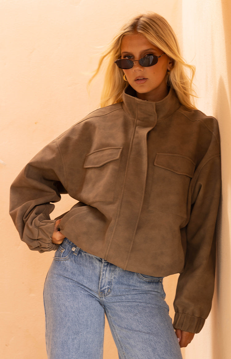Beginning Boutique Sapna Brown Oversized Funnel Neck Suedette Jacket — oversized brown suedette funnel neck jacket with front flap pockets and elasticated cuffs