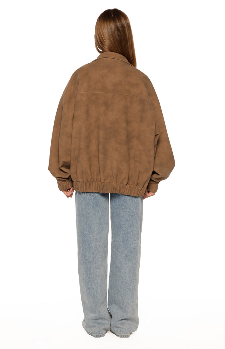 Rear view of an oversized brown suedette jacket with an elasticated hem and funnel neck collar
