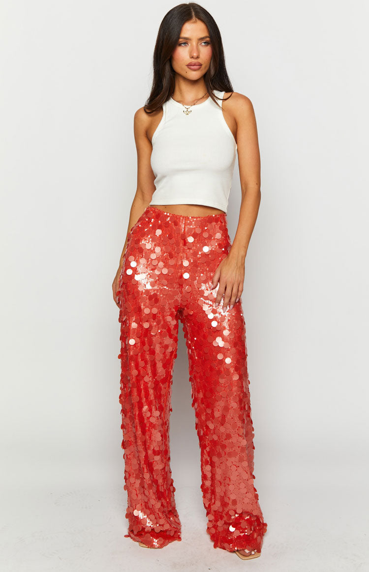 Full length front view of orange sequin wide-leg pants with a high waist and shimmering texture