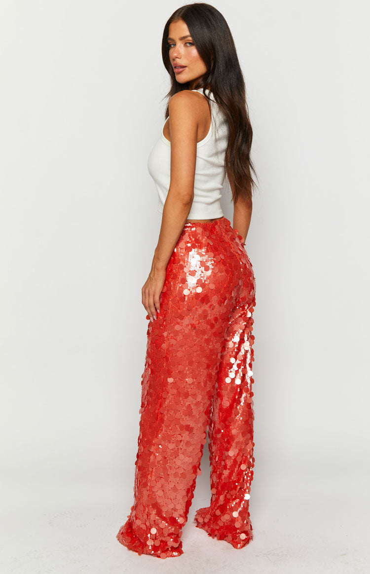 Side view of orange sequin wide-leg pants with all-over shimmer