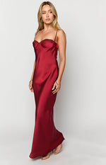 Angled view of a red satin maxi dress with a lace-trimmed sweetheart neckline and a flowing skirt