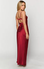 Side view of a red satin maxi dress showing the open back with a gold clasp and thin spaghetti straps