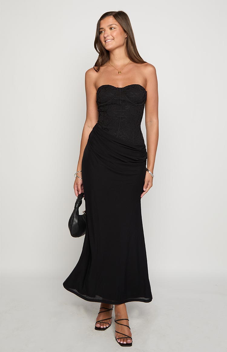 Front view of a black strapless corset maxi dress with lace bodice and ruched hip detail