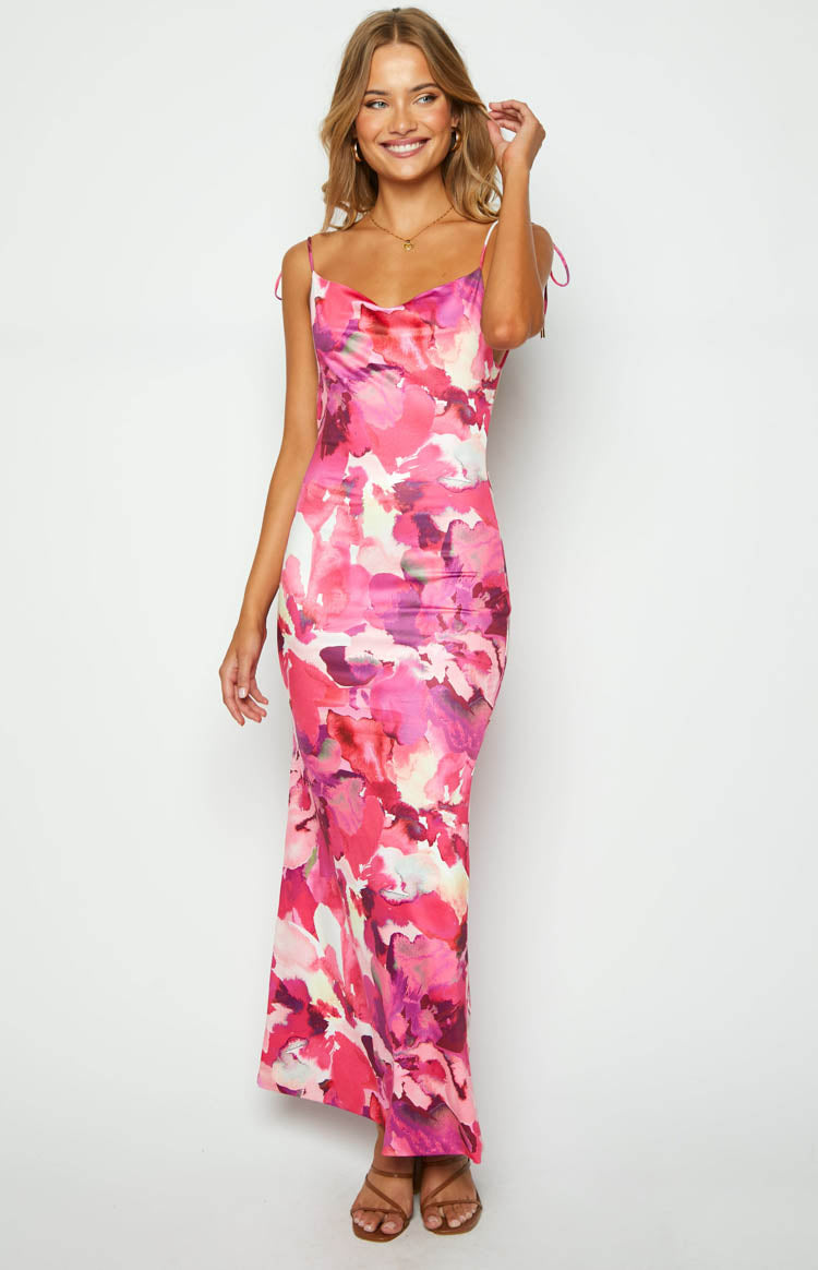 Full-length front view of a pink abstract floral print maxi dress with a cowl neck and tie-up spaghetti straps