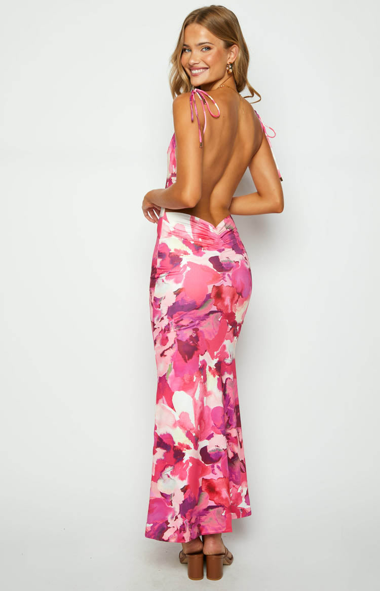 Rear view of the pink floral print maxi dress with a low open back, tie shoulder straps, and ruched skirt detail