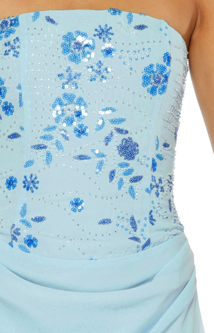 Close-up of the light blue strapless bodice with intricate blue and silver sequin and bead floral patterns and draped skirt