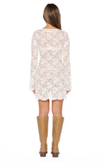 Rear view of the white floral lace mini dress with a scooped back and long sleeves