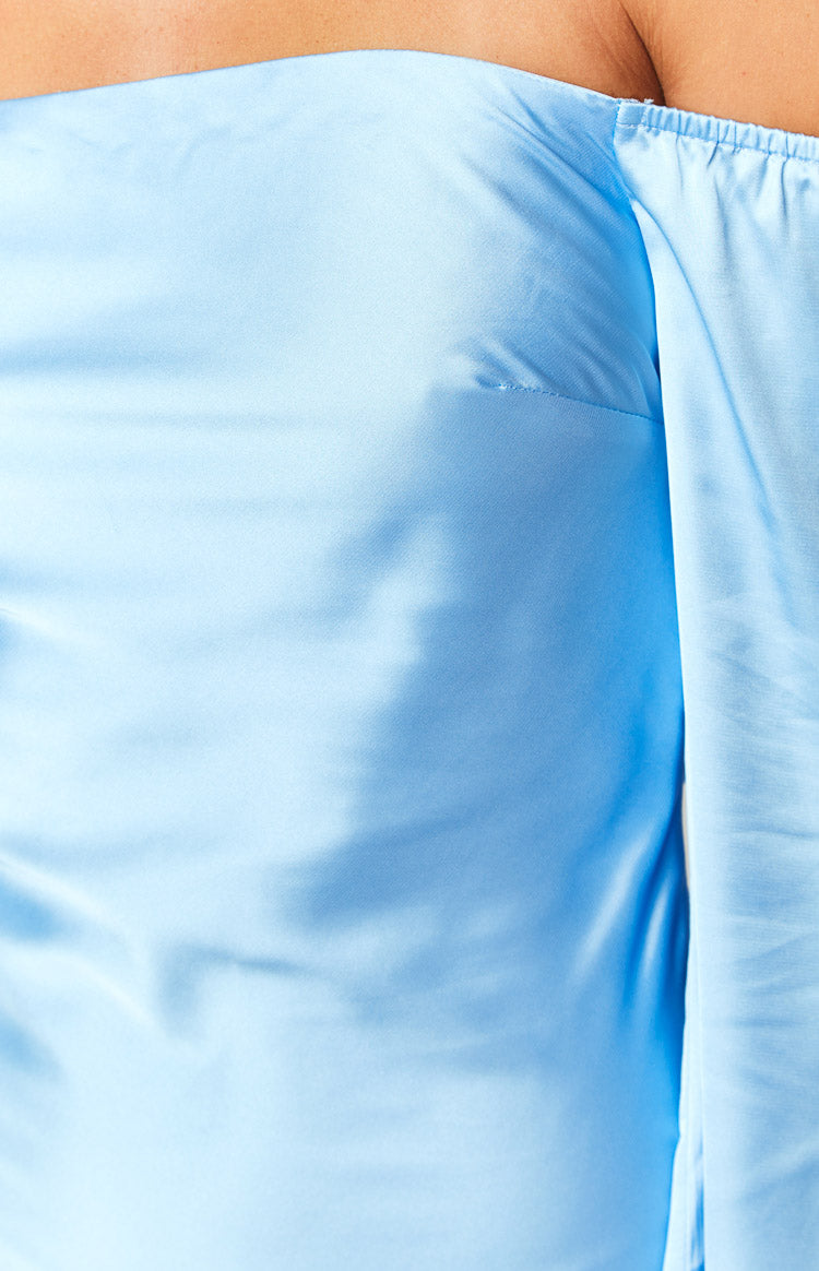 Close-up of the light blue satin fabric, off-shoulder neckline, and gathered sleeve detail of the maxi dress