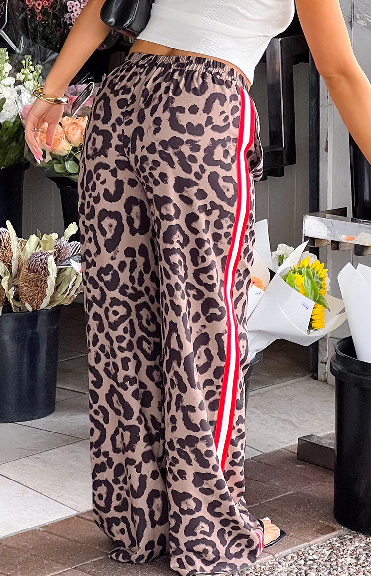 Beginning Boutique Sharly Leopard Red Racer Stripe Pants leopard print wide-leg pants with red and white racer stripe and elasticated waist