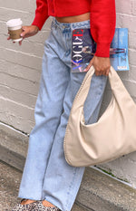 Relaxed fit light wash wide leg boyfriend jeans with a button waist and distressed hem