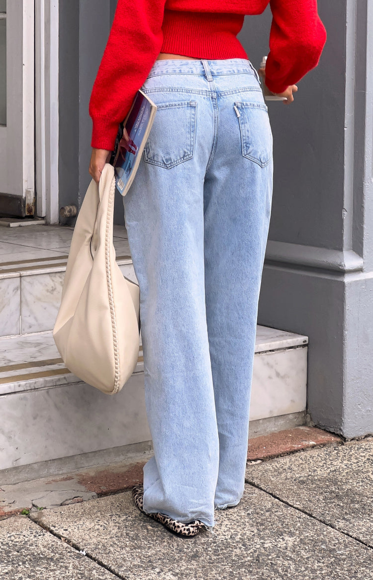 Rear view of light wash denim wide leg boyfriend jeans with classic back pockets and a relaxed fit