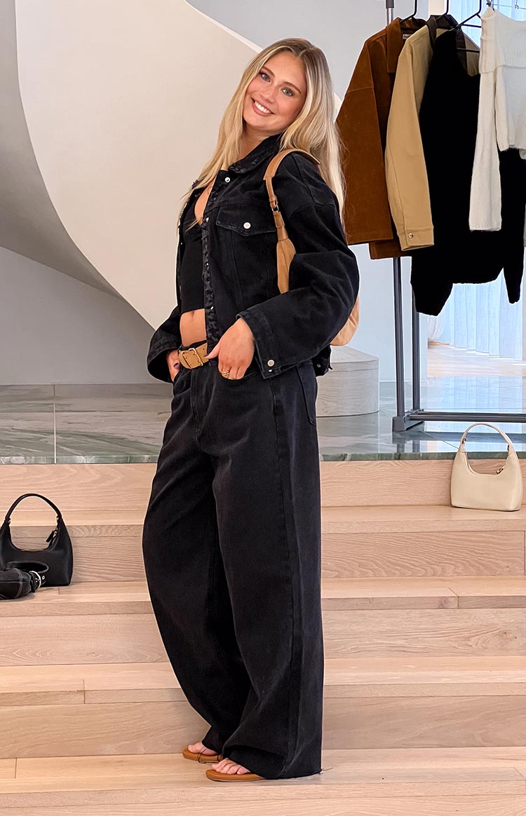 Full length view of black washed denim wide leg boyfriend jeans with a relaxed fit