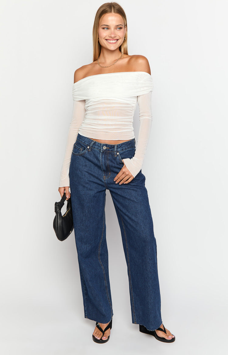 Dark wash denim wide leg boyfriend jeans with a mid-rise waist, front pockets, and raw hem