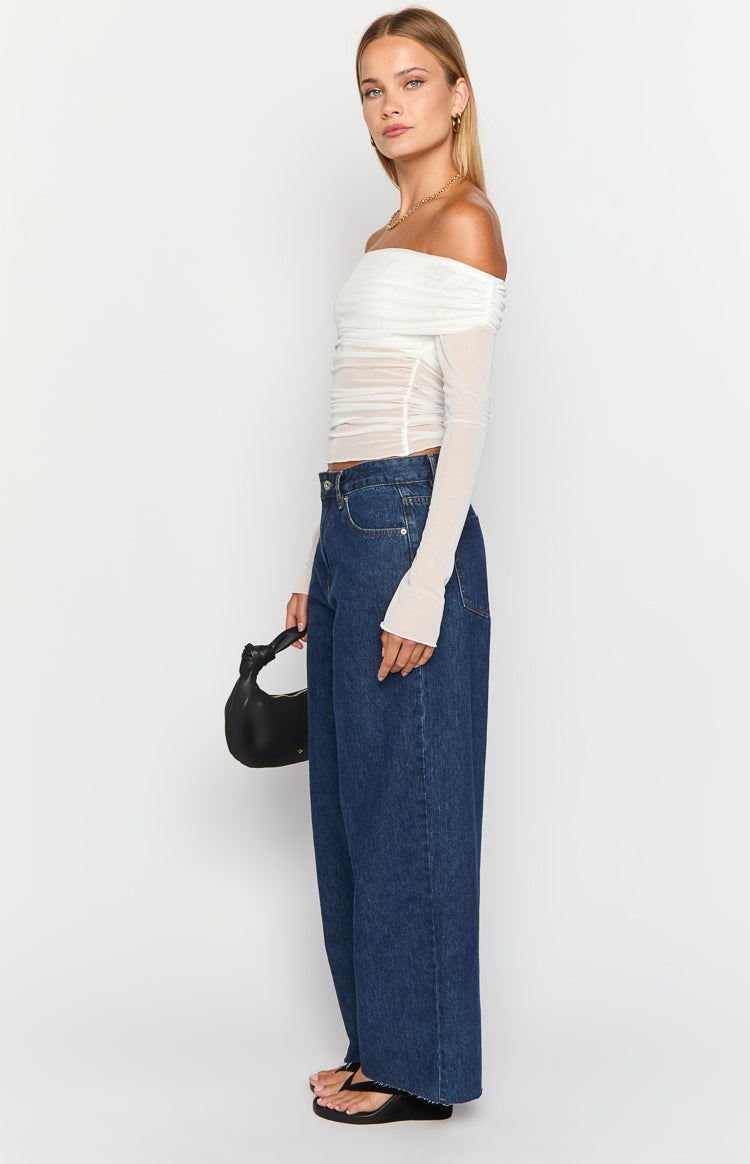 Side view of dark wash denim wide leg boyfriend jeans, highlighting the relaxed silhouette