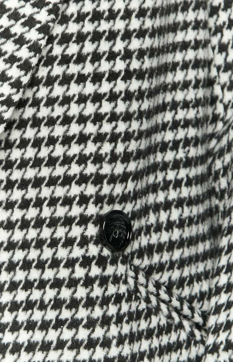 Close-up of the black and white houndstooth pattern fabric with a black button