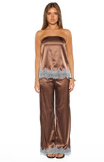 Front view of a brown satin strapless top with light blue scalloped lace trim at the hem