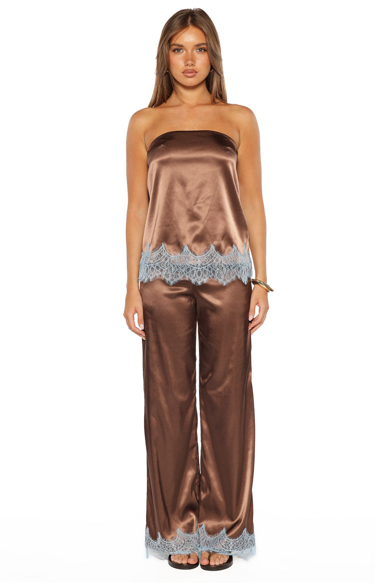 Full length view of brown satin wide-leg pants with light blue scalloped lace trim at the hem
