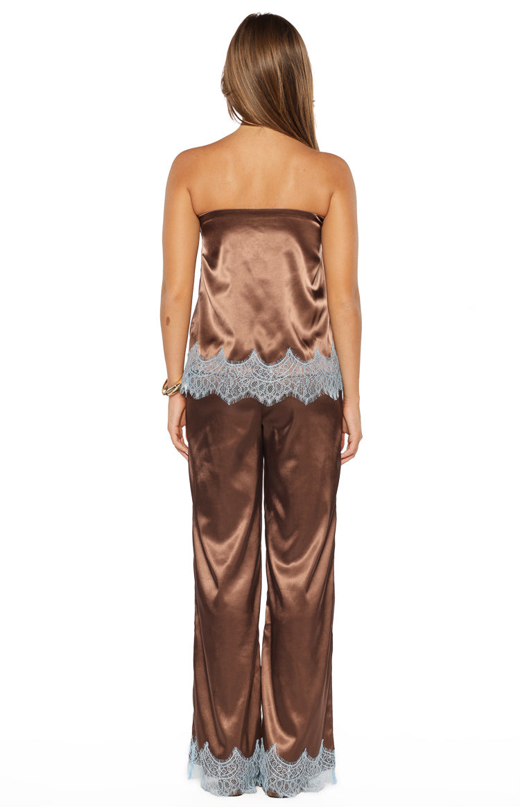 Rear view of brown satin wide-leg pants with light blue lace trim at the hem