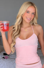 Close-up of the light pink jersey halter singlet, showing white horizontal stripes across the bust and a solid pink lower bod