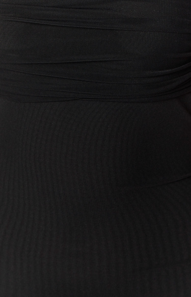 Close-up of the gathered black mesh fabric detail on the mini dress