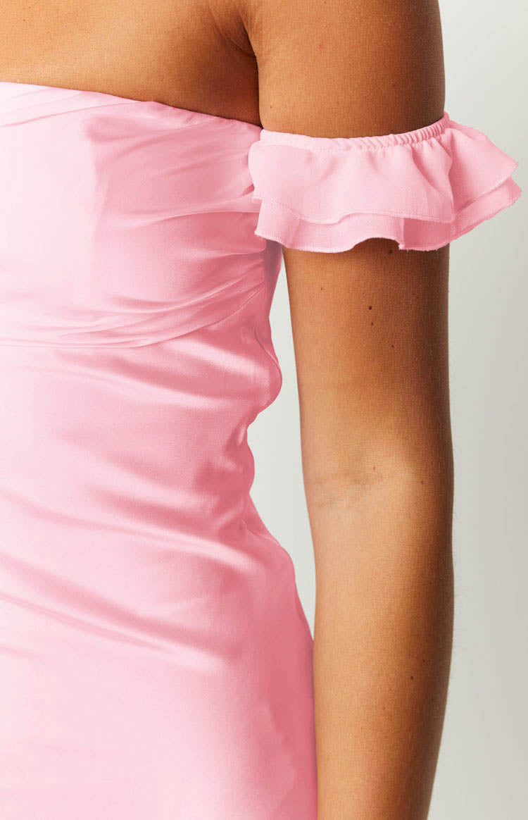 Detail shot of the pink satin mini dress showing the elasticated ruffled off-shoulder sleeve and ruched bodice