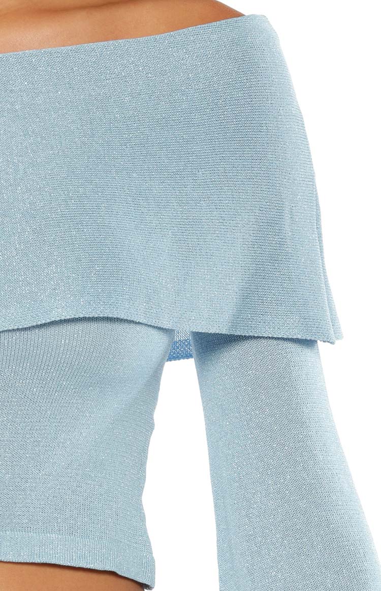 Close-up of the blue shimmer knit off-shoulder top with a draped neckline and long flared sleeve