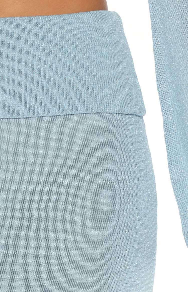 Close-up of the blue knit skirt's folded waistband and fine shimmery texture