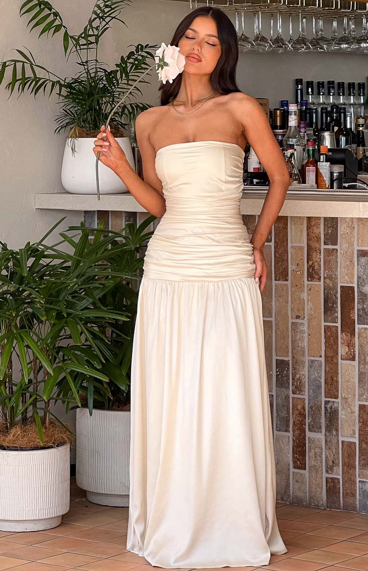 Beginning Boutique Sinclair Cream Satin Strapless Maxi Dress cream satin strapless maxi dress with a ruched bodice and flowing skirt