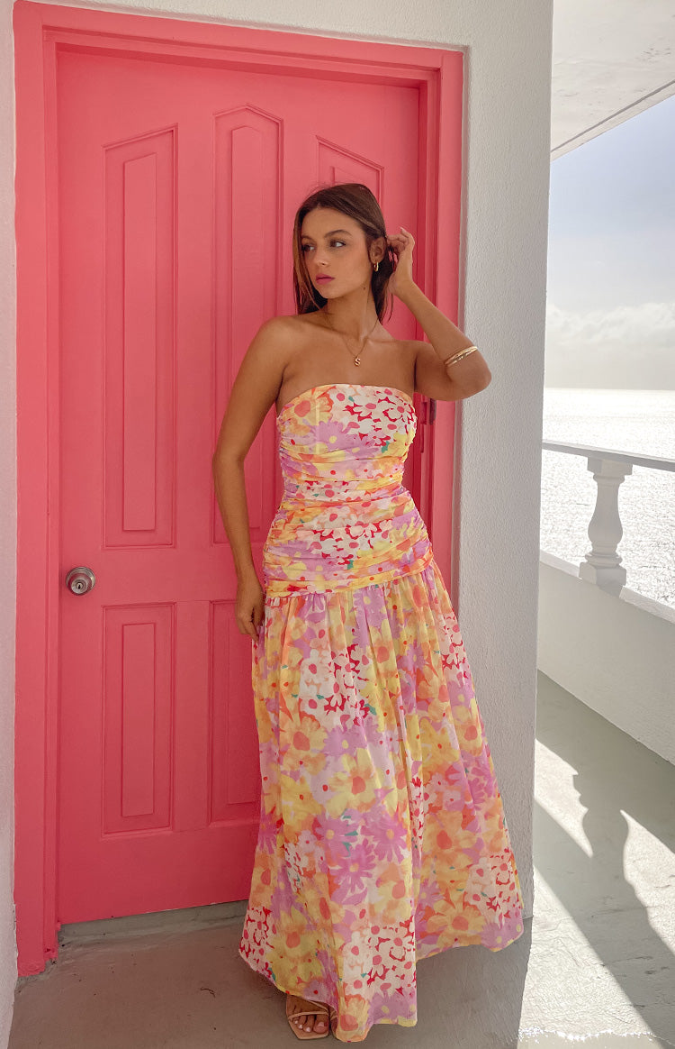 Yellow floral print strapless maxi dress with a ruched bodice and a full, flowing skirt