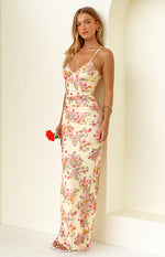 Full length view of a yellow floral maxi dress with V-neck, spaghetti straps, and side ruching